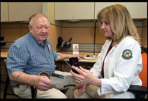 Veteran Leonard Englebrook and VA New Jersey Health Care System Nurse Margaret Hogan, RN, review the use of a cell phone for Telehealth. 